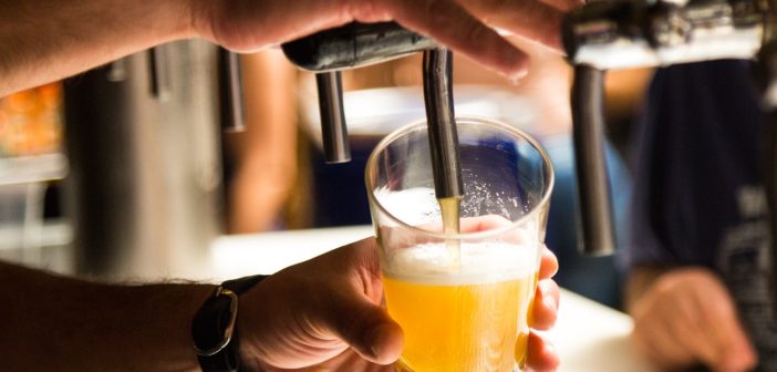 Ein Bier wird in einer Kneipe gezapft.